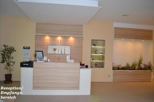 a pharmacyacist with a counter in a room at City-Hotel Cottbus in Cottbus