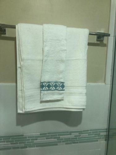 un grupo de toallas colgando de un toallero en el baño en Oceana, en Portmore