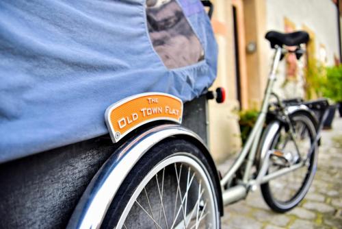 a bike parked next to a car with a sign on it at The Old Town Flat in Murten