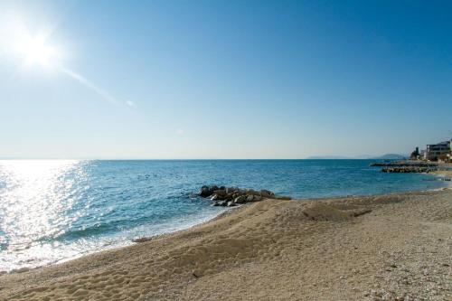 a beach with some rocks in the water at Villa Tamaris on the beach in Podstrana