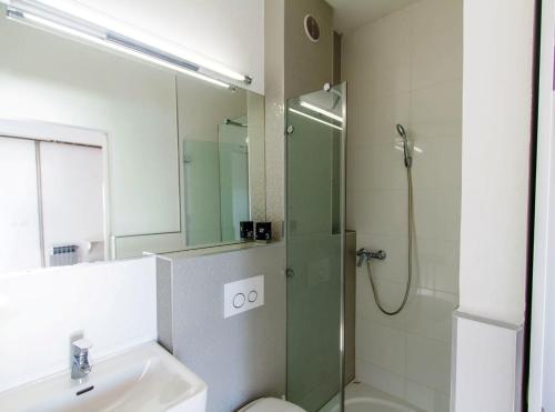 a bathroom with a shower and a toilet and a sink at Villa Tamaris on the beach in Podstrana