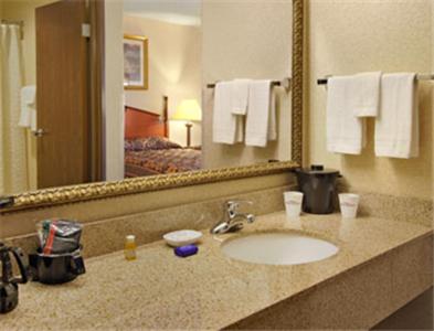 a bathroom with a sink and a large mirror at Baymont by Wyndham Corydon in Corydon