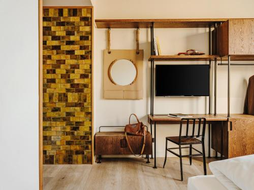 a room with a desk and a chair and a mirror at Sonder Casa Luz in Barcelona