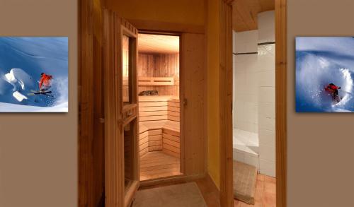 a door into a room with two pictures on the wall at Hôtel Saint-Martin in Saint-Martin-de-Belleville