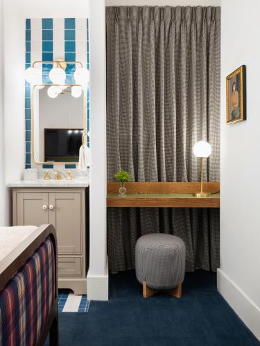 a hotel room with a sink and a mirror at Palihotel San Diego Gaslamp Quarter in San Diego