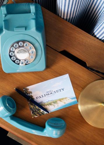 a table with a telephone and a book on it at Palihotel San Diego Gaslamp Quarter in San Diego