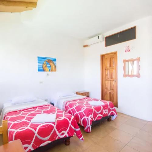 Cama o camas de una habitación en Galapagos Verde Azul