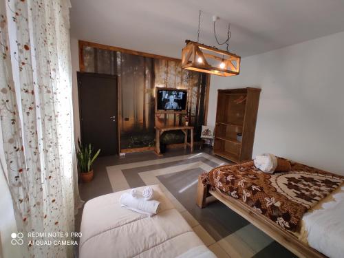 a bedroom with a bed and a dresser and a tv at Villa Sofia in Pettorano sul Gizio