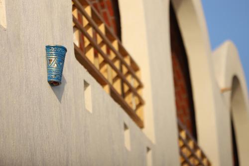 a blue cup on the side of a building at Noprea Boutique Hotel in Aswan