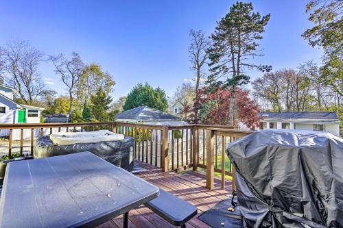 a wooden deck with a table and chairs on it at Middletown Township Home, Close to Beaches! in Leonardo