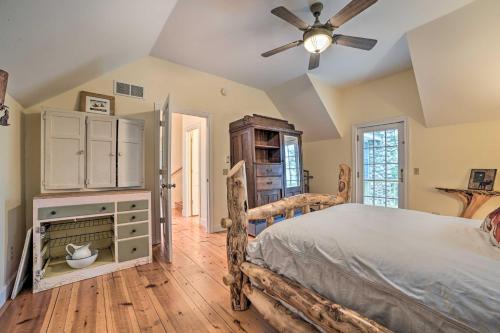 a bedroom with a bed and a ceiling fan at Waterfront Cheboygan Home with Fire Pit in Cheboygan