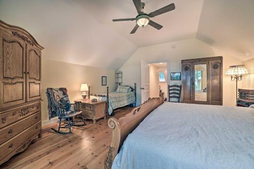 a bedroom with a large bed with a ceiling fan at Waterfront Cheboygan Home with Fire Pit in Cheboygan