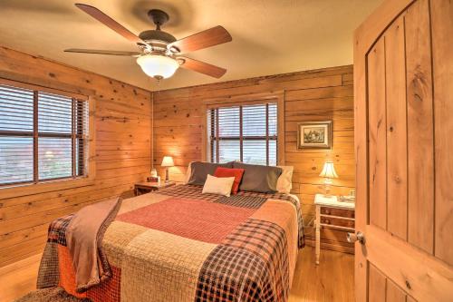 a bedroom with a bed and a ceiling fan at Charming Cabin with Hot Tub, Fire Pit and Views! in Jasper