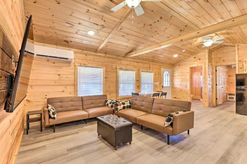 a living room with two couches and a flat screen tv at Laurelville Cabin Less Than 11 Mi to Old Mans Cave! in Laurelville