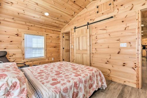 a bedroom with a bed in a wooden room at Laurelville Cabin Less Than 11 Mi to Old Mans Cave! in Laurelville