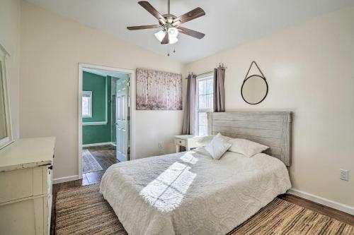 een slaapkamer met een bed en een plafondventilator bij Gray Home with View of Boone Lake and Fire Pit! 