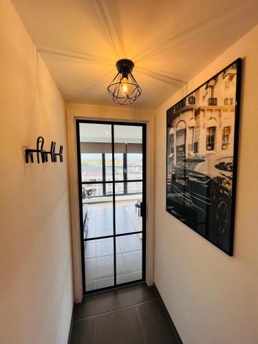 a hallway with a door to a room with a window at Penthouse with awesome terrace and free parking in Kortrijk