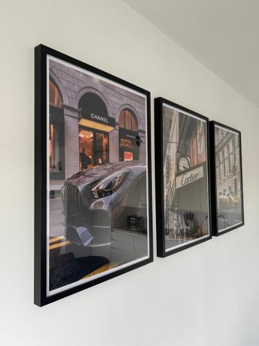 three framed photographs of a car on a wall at Penthouse with awesome terrace and free parking in Kortrijk