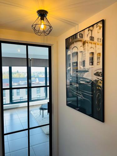 a room with a picture on the wall and a window at Penthouse with awesome terrace and free parking in Kortrijk