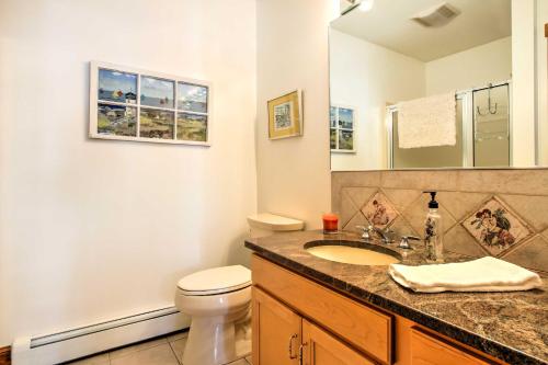 a bathroom with a sink and a toilet and a mirror at Large Kennebunk Home, Walk to Beach Less Than 2 Mi to Town in Kennebunk