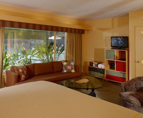 a living room with a couch and a table at Orbit In - 21 and Over in Palm Springs