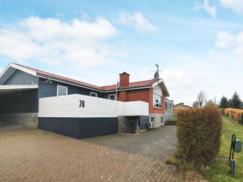 a house with a garage and a driveway at 10 person holiday home in Roslev in Flovtrup