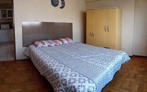 a bedroom with a large bed with two pillows at APARTAMENTO, CENTRO DE LA CUIDAD in Cochabamba