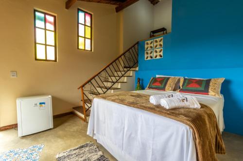 Łóżko lub łóżka w pokoju w obiekcie Pousada Casa do Geninho