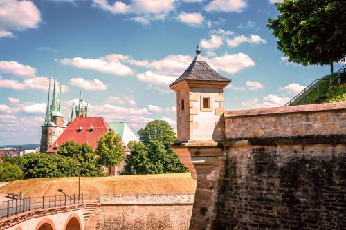 an old brick wall with a tower and a bridge at Apartment DOM II - Erfurt Domplatz in Erfurt