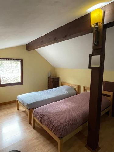 a bedroom with two beds in a room at Maison cosy proche de font romeu in Latour-de-Carol