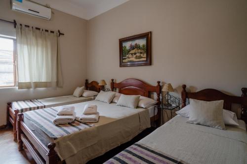 a bedroom with two beds with towels on them at Munay San Salvador de Jujuy in San Salvador de Jujuy