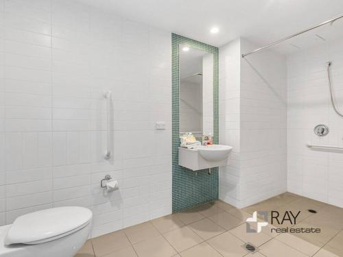 a bathroom with a toilet and a sink and a shower at Peppers Plunge Pool Perfection 2br spa suite in Kingscliff