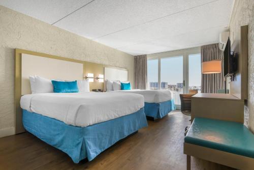 a hotel room with two beds and a large window at Inn on Destin Harbor, Ascend Hotel Collection in Destin