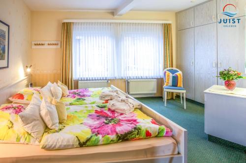 a hotel room with a large bed in a room at Haus Petra 131 - Ferienwohnung 1 in Juist