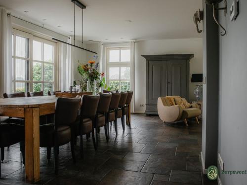 a dining room with a table and chairs at Country house next to a nature reserve in Leende