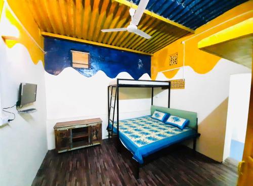 a room with a bed in a room with a ceiling at Housetel in Jaipur
