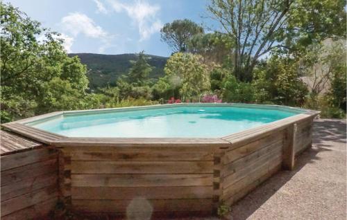a large swimming pool with a wooden fence around it at Awesome Home In Lamalou Les Bains in Lamalou-les-Bains