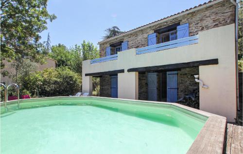 a swimming pool in front of a house at Awesome Home In Lamalou Les Bains in Lamalou-les-Bains