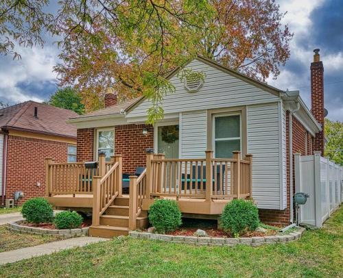 a small house with a wooden deck in the yard at Beautiful Modern home with all year use HOT TUB, Pool table, Game room, & Propane fire pit!! in Ferndale