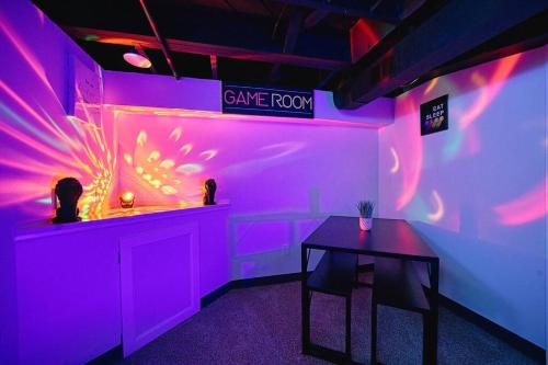 a purple room with a table and a sign on the wall at Beautiful Modern home with all year use HOT TUB, Pool table, Game room, & Propane fire pit!! in Ferndale