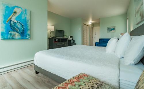 a bedroom with a large bed with a bird painting on the wall at Embarcadero Resort in Newport