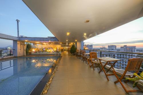 a balcony with a swimming pool on top of a building at Romance Hotel in Hue