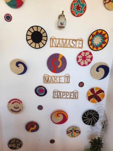 a wall with many different types of plates on it at Blue Eye Hostel in Jaisalmer
