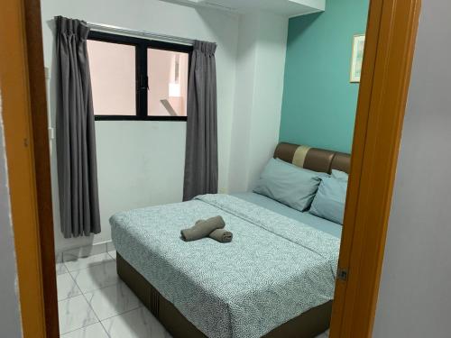 a bedroom with a bed with a stuffed animal on it at 2 bedroom 2 bathroom Paul Serene Ramin F201 in Genting Highlands