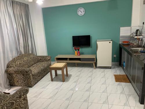 a living room with a couch a chair and a refrigerator at 2 bedroom 2 bathroom Paul Serene Ramin F201 in Genting Highlands