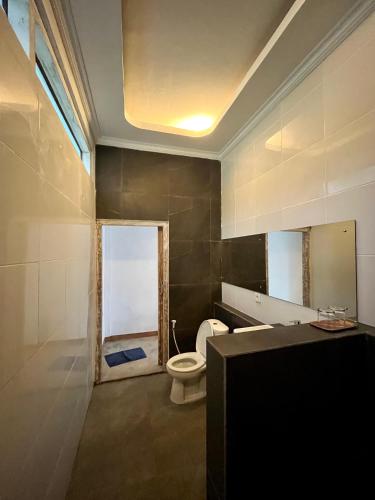 a bathroom with a toilet and a sink at Sanctum Hotel and Dive- Nusa Penida in Nusa Penida