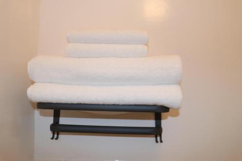 a stack of towels on a towel rack at attomi hostel in Sapporo