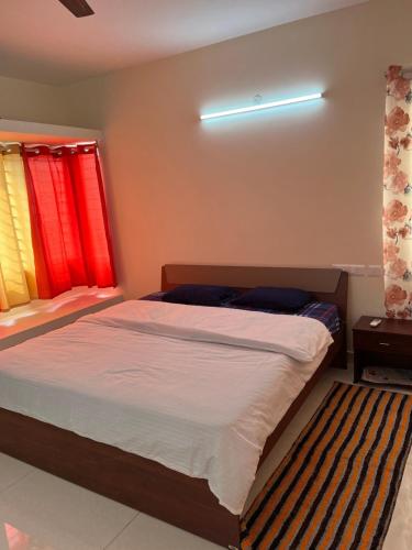 A bed or beds in a room at IP Service Apartment near Chennai Airport