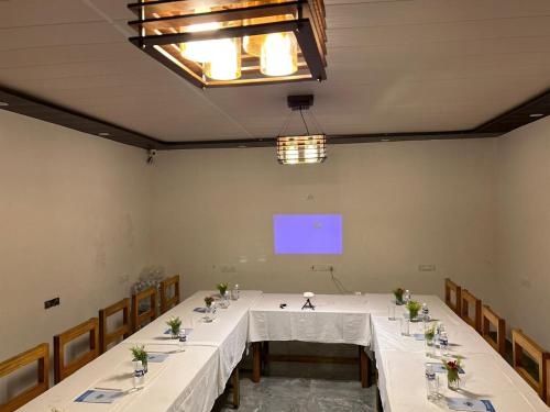 a large room with a table with a white table cloth at Seven Corbett in Rāmnagar