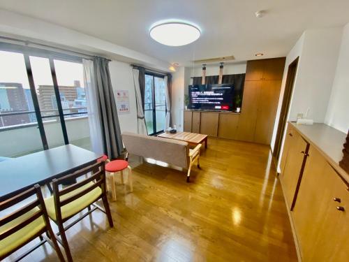 a living room with a couch and a table at Hotel EL 8（宇都宮駅東口） in Utsunomiya